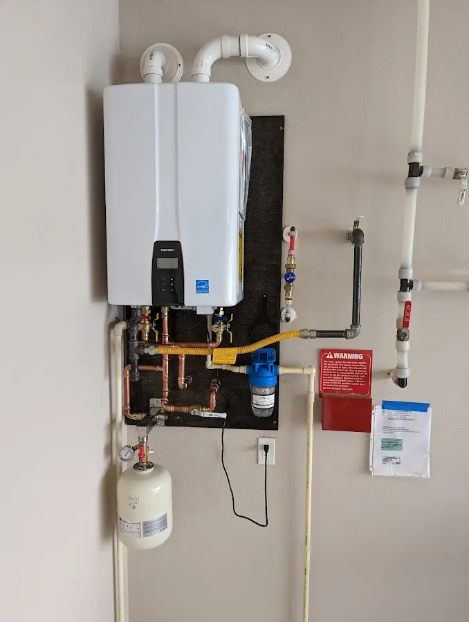 Professional plumber installing copper piping in a Spokane home
